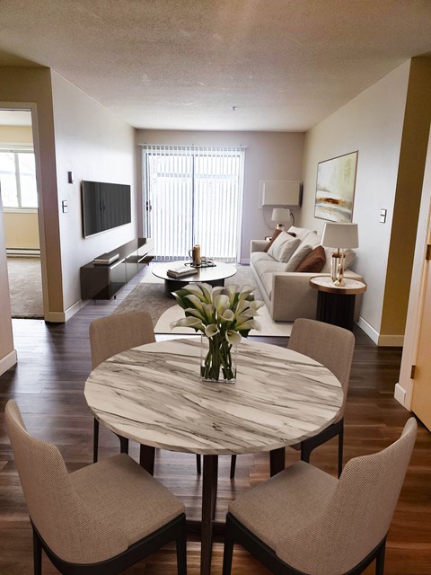 a living room and dining room with a table and chairs