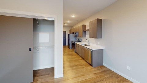 A kitchen with wooden floors and white walls.