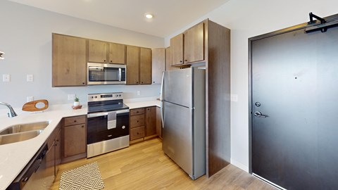 a kitchen with stainless steel appliances and wooden cabinets