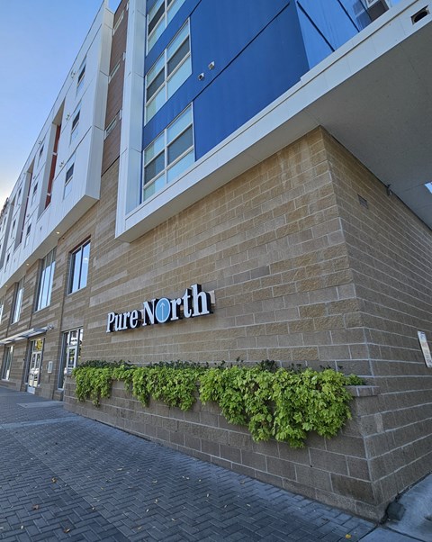 a brick building with a pine north sign on the side of it