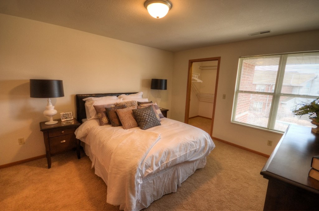 a bedroom with a large bed and a window