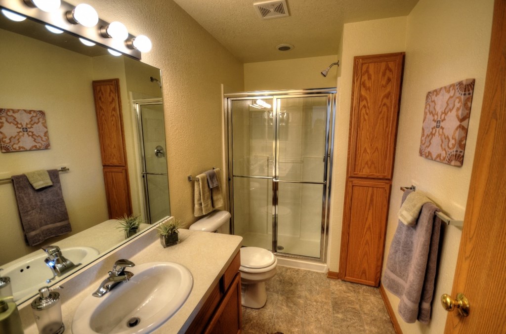 a bathroom with a sink toilet and shower
