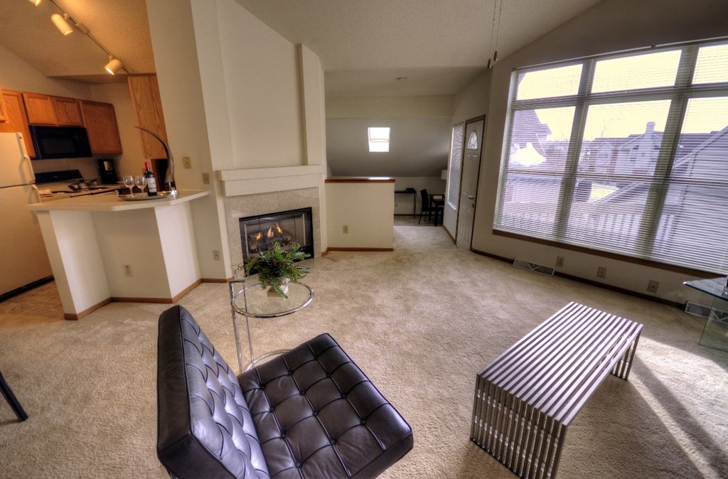 an open living room with a fireplace and a couch