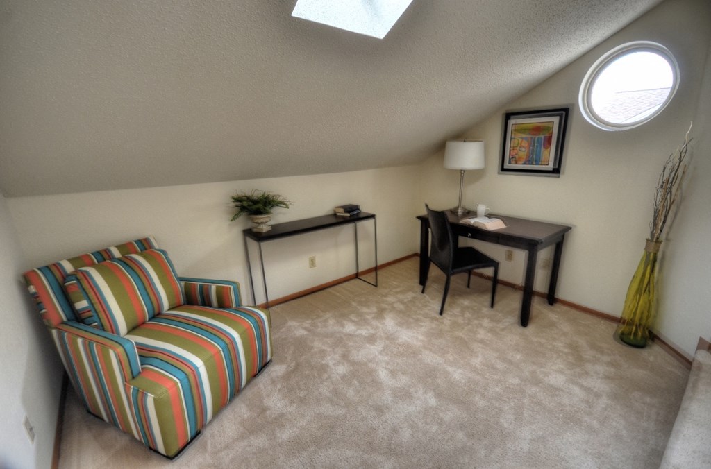 a loft room with a couch and a table