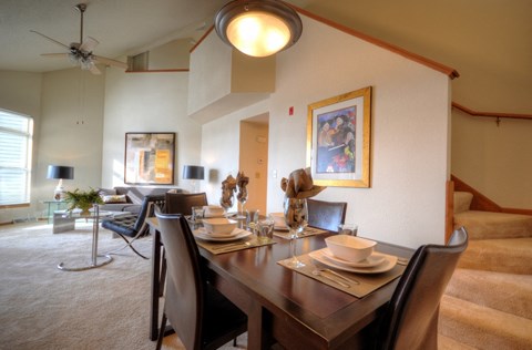 a dining room and living room with a table and chairs