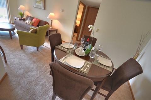 a dining room with a table and chairs in a hotel room