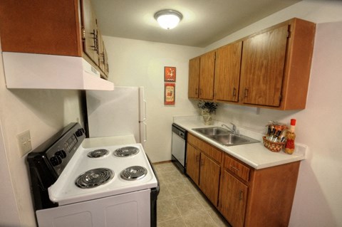 A small kitchen with a stove and sink.
