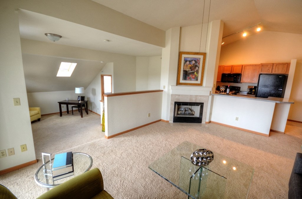 a living room with a fireplace and a glass table