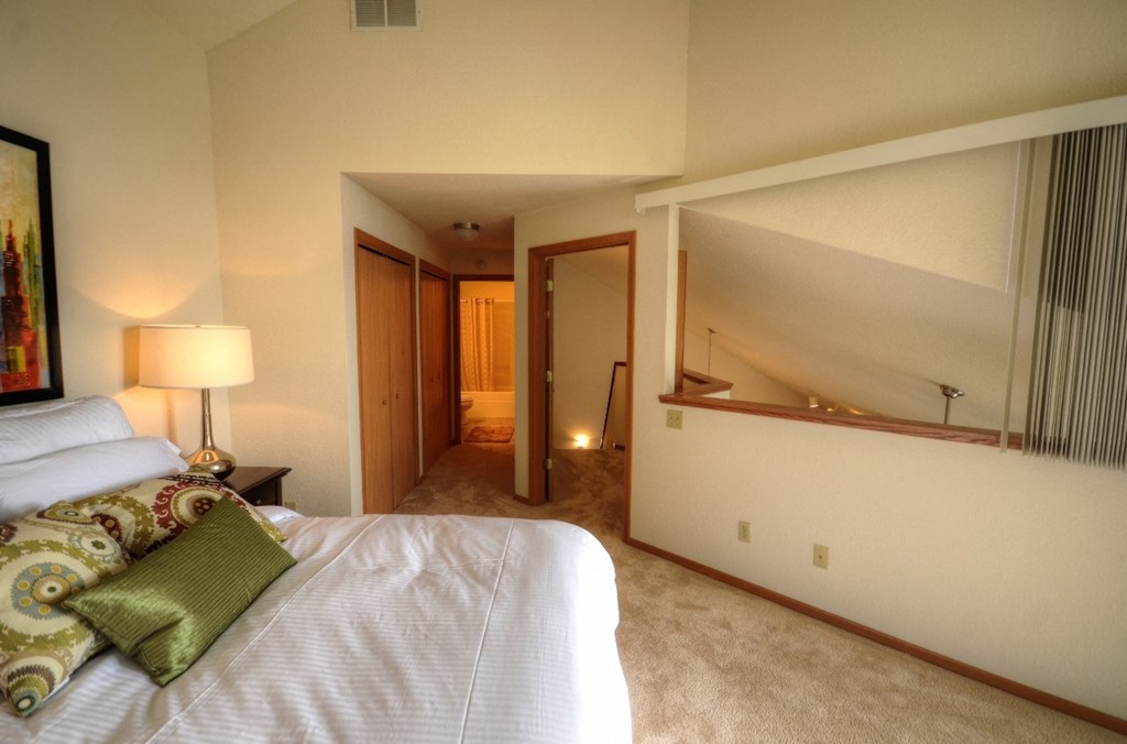 a bedroom with a bed and a mirror