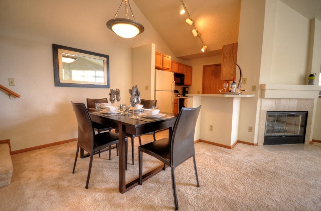 a dining room with a table and chairs and a fireplace
