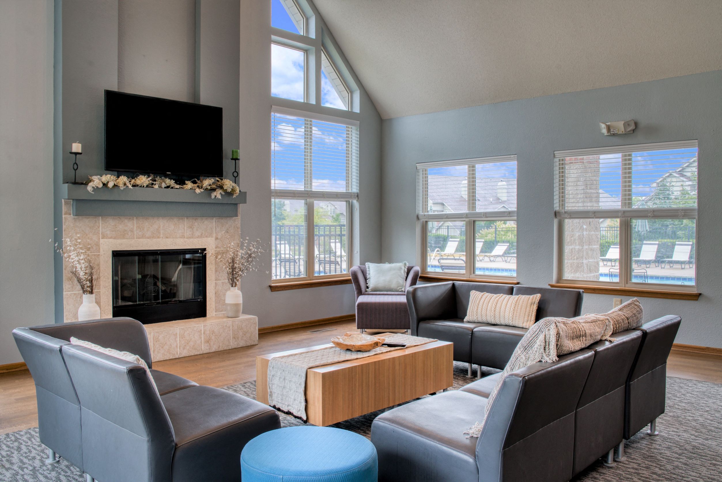 a living room with couches and a fireplace and a television