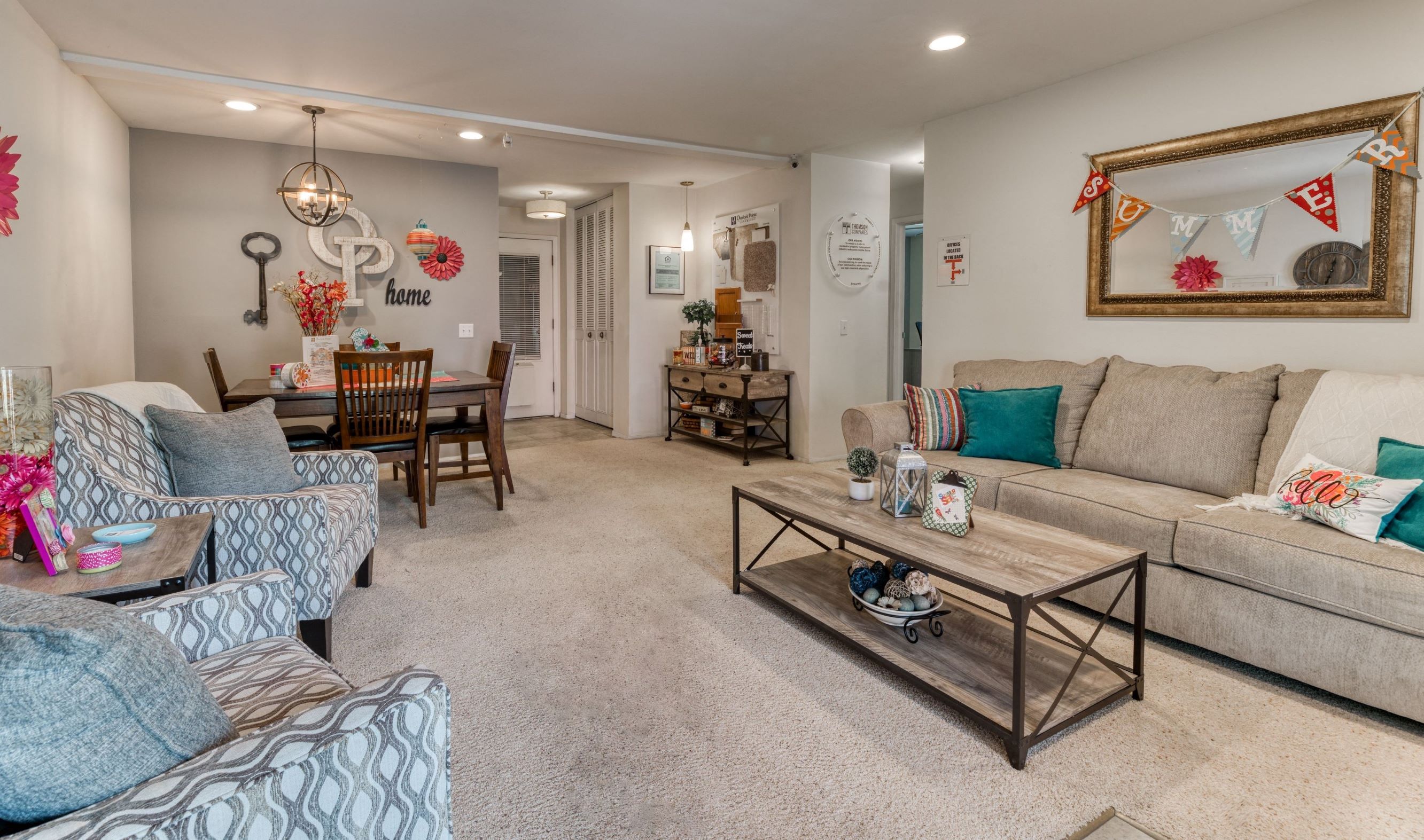 a living room with couches and chairs and a table