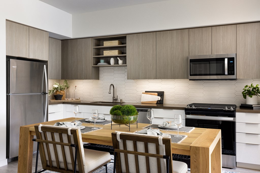 Modern kitchen featuring bar style seating at Sixth & Jackson apartments in San Jose.