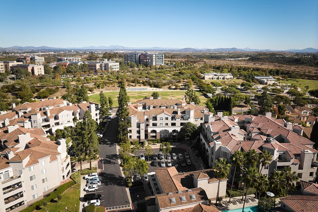 A view of a residential area with buildings and cars at Valentia Apartments in La Jolla.