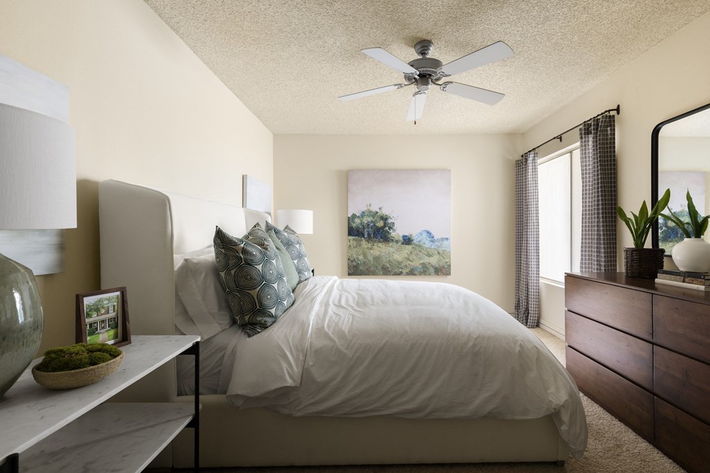 Bedroom with ceiling fan and carpeted flooring at Cerritos Apartments