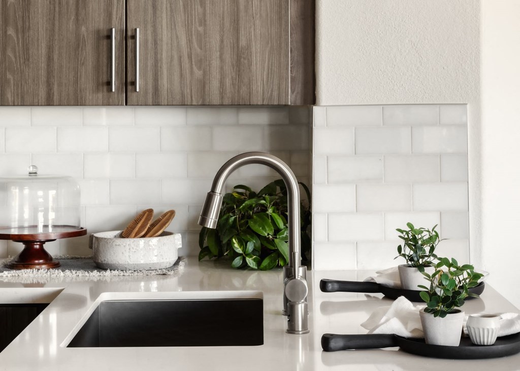 Updated kitchens include subway tile backsplash at City Lights at Town Center Apartments in Aliso Viejo