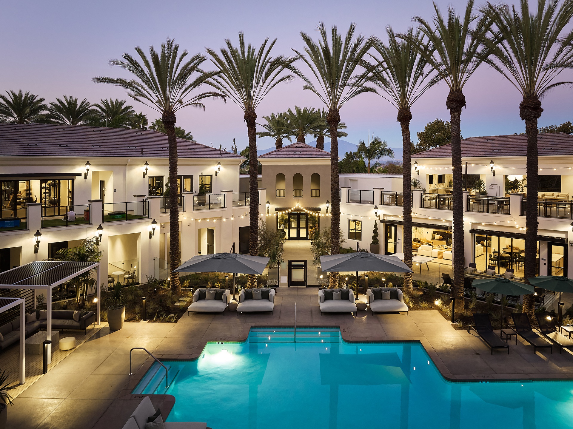 Aerial view of the pool area, clubhouse, and fitness center