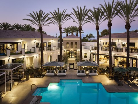 Aerial view of the pool area, clubhouse, and fitness center