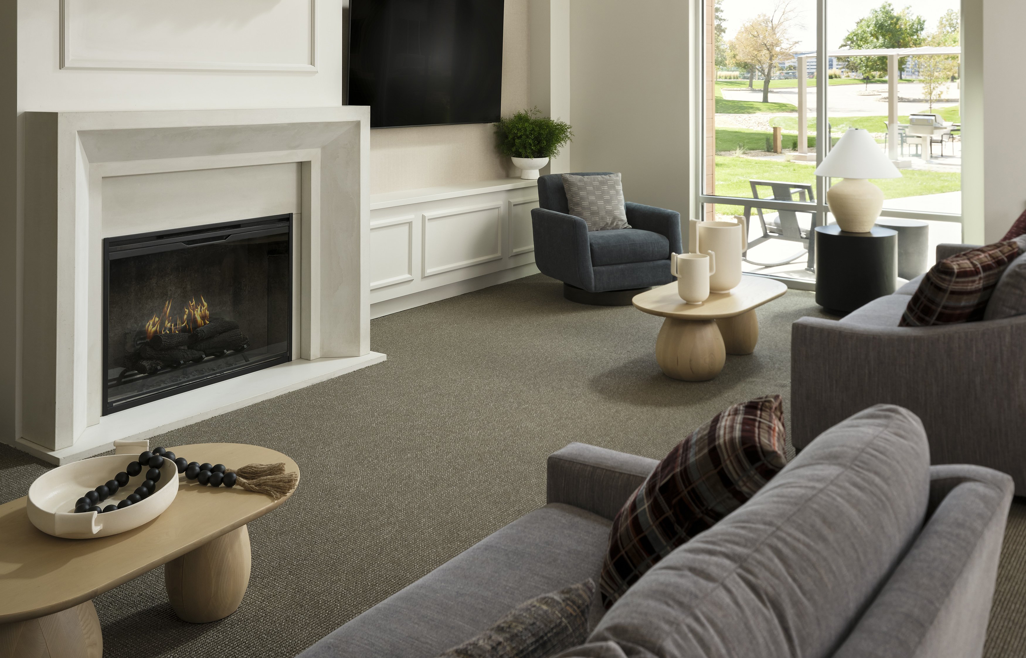 A cozy, spacious living room with a fireplace at The Sophia in Englewood.