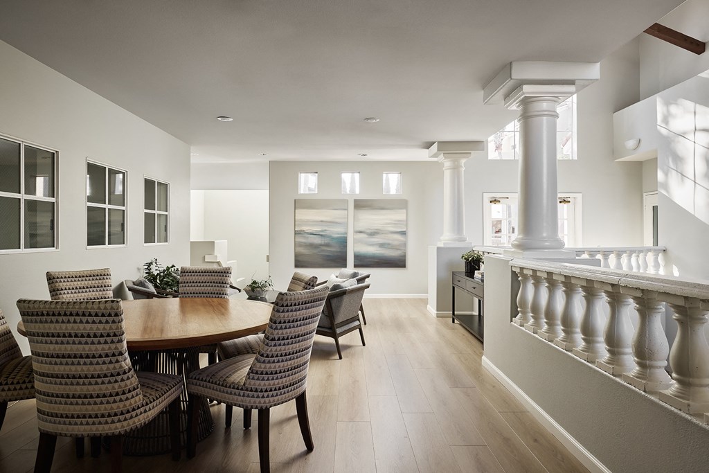 A dining room with a table and chairs at Valentia Apartments in La Jolla.
