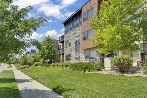 Exterior shot of the apartment complex featuring walkways at Vela Meridian Apartments in Parker.