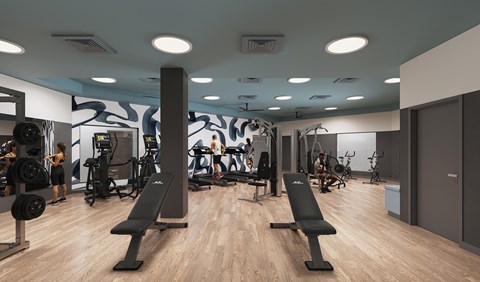 The fitness center amenity with weight benches and cardio machines at Lofts on Monaco in Denver.