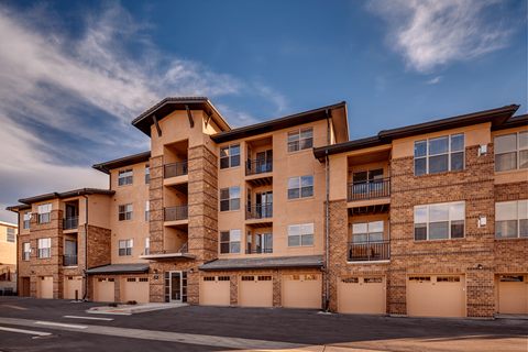 Exterior of the apartment complex featuring garages at Zenith Meridian apartments in Englewood.