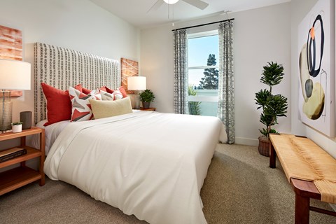 Modern style model bedroom with a window at Symmetry apartments in Northridge.
