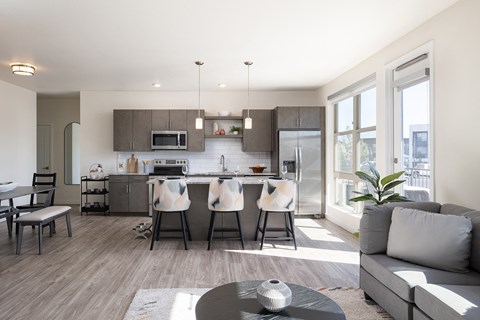 A modern kitchen with a dining table and chairs.