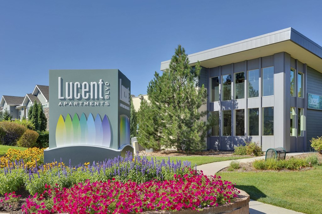 Monument sign and exterior of resident clubhouse at Lucent Blvd Apartments in Highlands Ranch