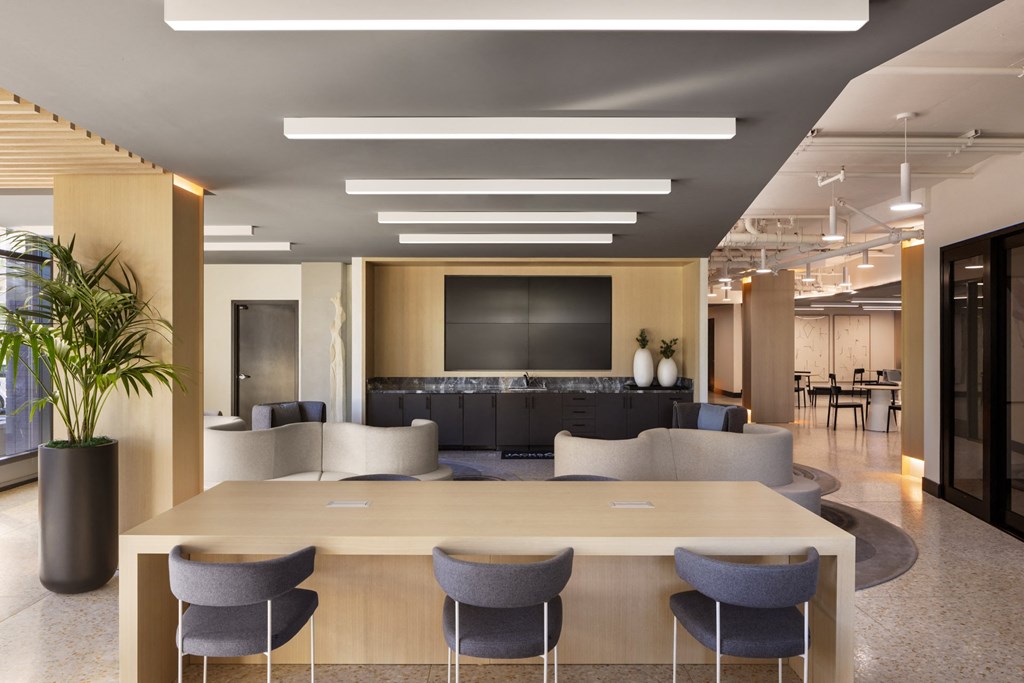 Coworking lounge with community seating at Sixth & Jackson apartments in San Jose.