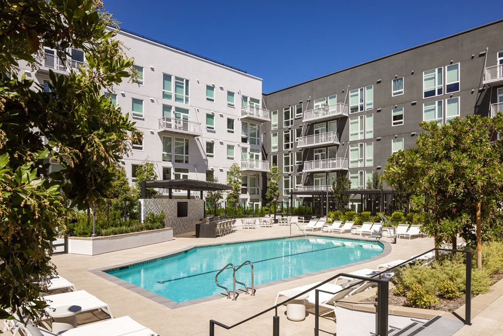 Outdoor pool amenity featuring the North building at Sixth & Jackson apartments in San Jose.