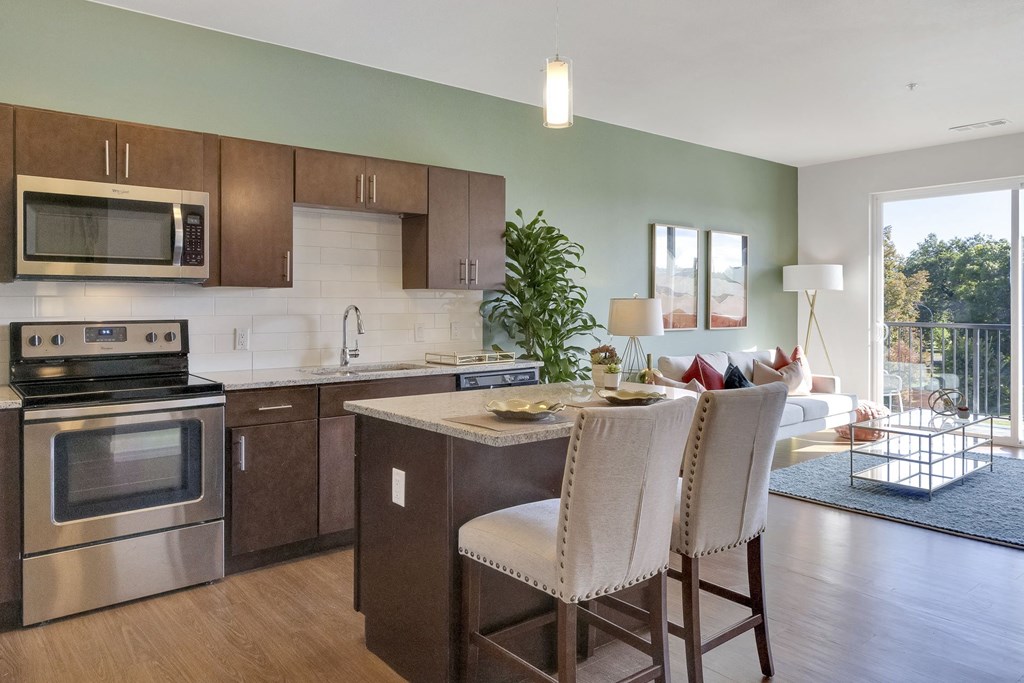 Kitchen with island and granite countertops at The York on City Park in Denver