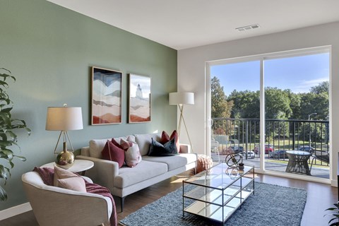 a living room with a couch and a glass coffee table