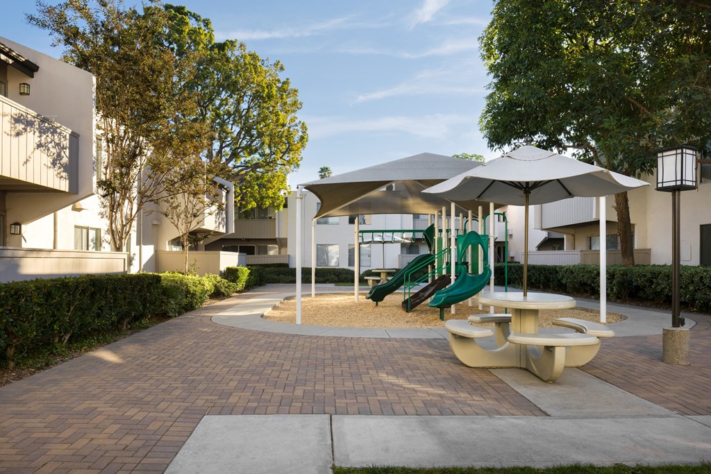 Playground area and picnic tables at Cerritos Apartments