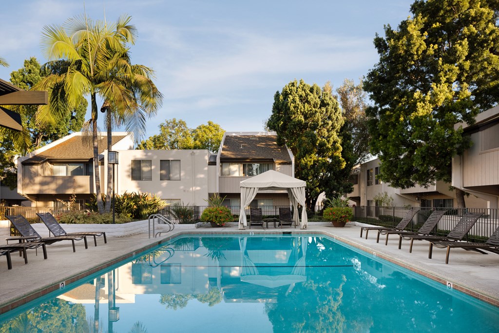 Covered cabana seating at the pool at Cerritos Apartments