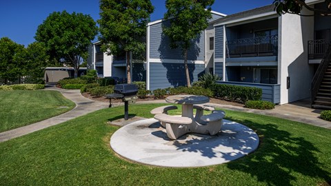 An outdoor seating area at Crystal Springs apartments in Fountain Valley.