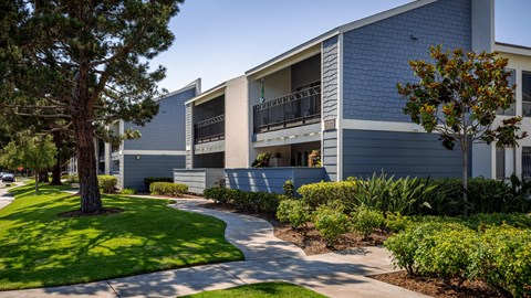 Exterior shot featuring walkways at Crystal Springs apartments in Fountain Valley.