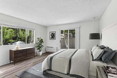 Remodeled bedroom with hard-surface flooring and large windows with natural light at Creekside Apartments in Fremont.