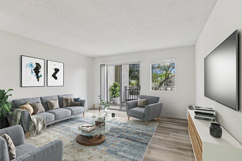 Remodeled living area showing the patio with a view of the surrounding trees at Creekside Apartments in Fremont.