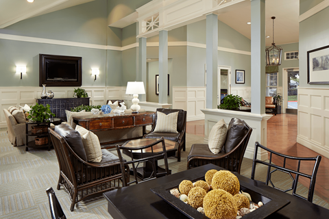 Resident lounge with seating areas and co-working spaces at Creekside Apartments in Fremont.