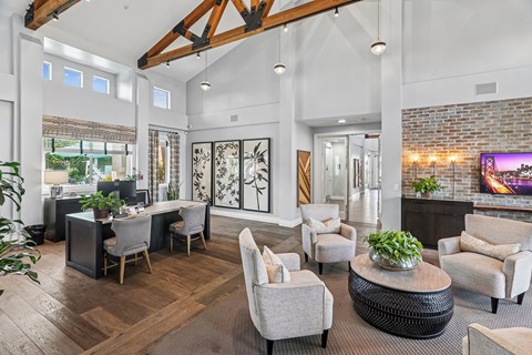 A modern living room with a wooden floor and a large window.