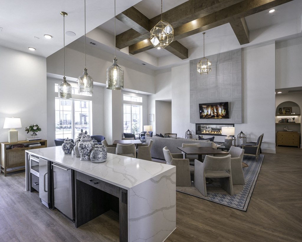 a large living room and dining room with a marble counter top