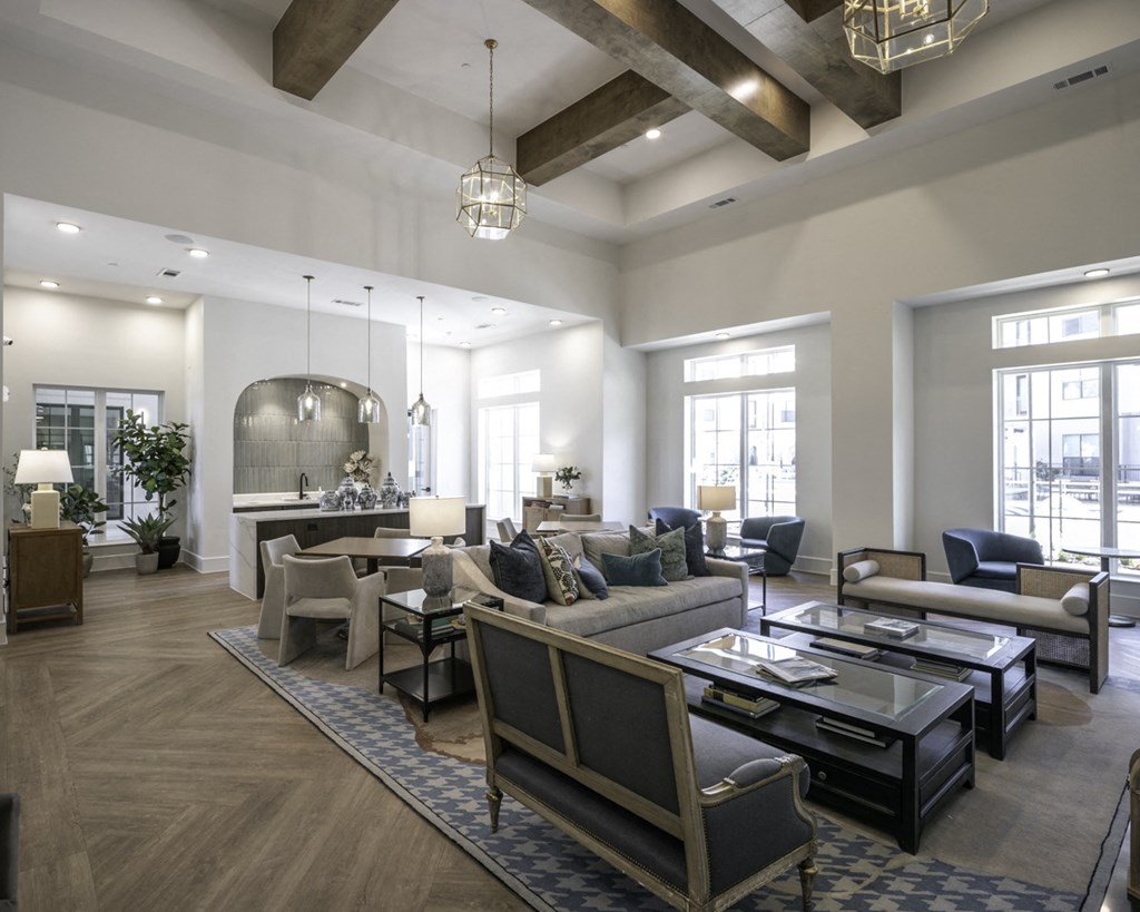 a large living room with couches and chairs