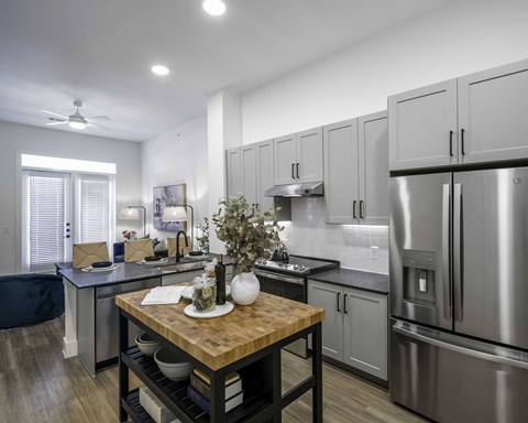a kitchen with stainless steel appliances and a wooden table