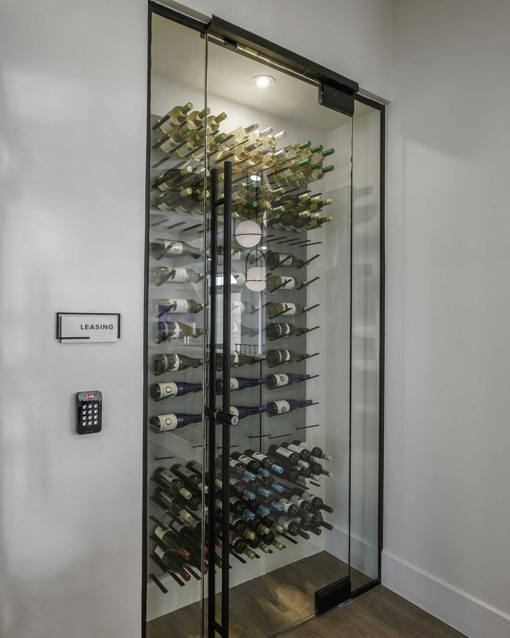 a glass wine cellar in the corner of a room