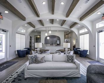 a living room filled with furniture and a large window