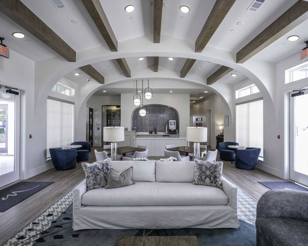 community room filled with furniture and a large windows