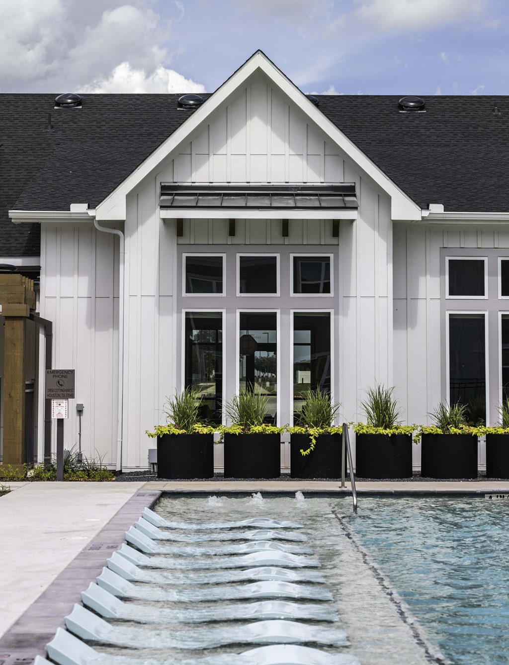 Clubhouse exterior with floating pool chairs