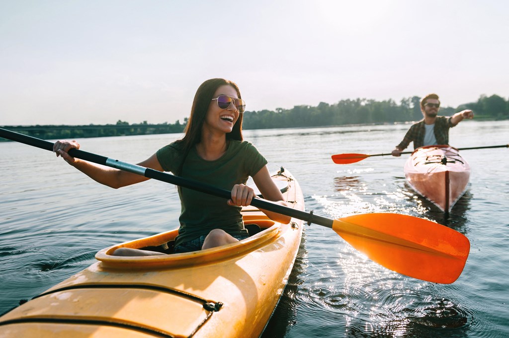 two people in kayaks on a lake